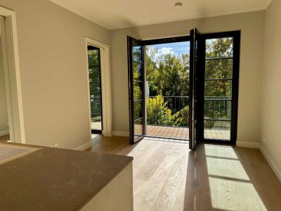 Helle 2-Zimmer-Neubauwohnung mit Südbalkon und Tischlereinbauten im SIGNUM nahe Ludwigkirchplatz