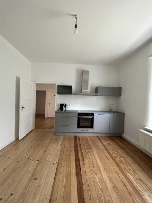 Charmante 2-Zimmer-Wohnung mit Wohnküche und Kamin im Hessheimer Viertel