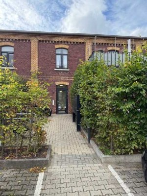 Wohnen mit Geschichte: 2 Zimmer Erdgeschosswohnung mit Terrasse und Küche in der alten Seidenweberei